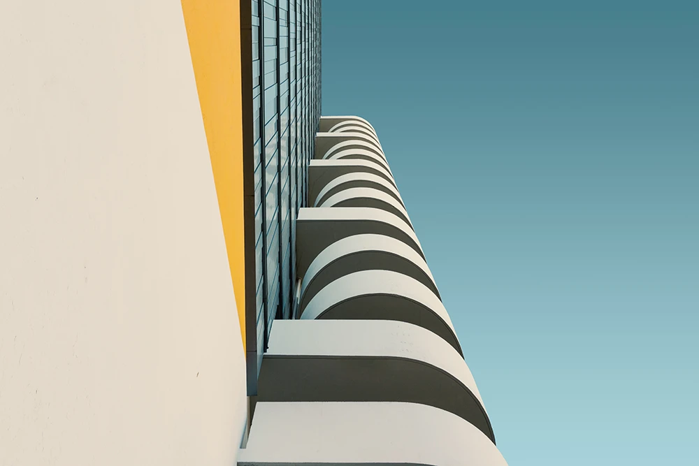 Low angle shot of a white concrete building under the clear blue sky